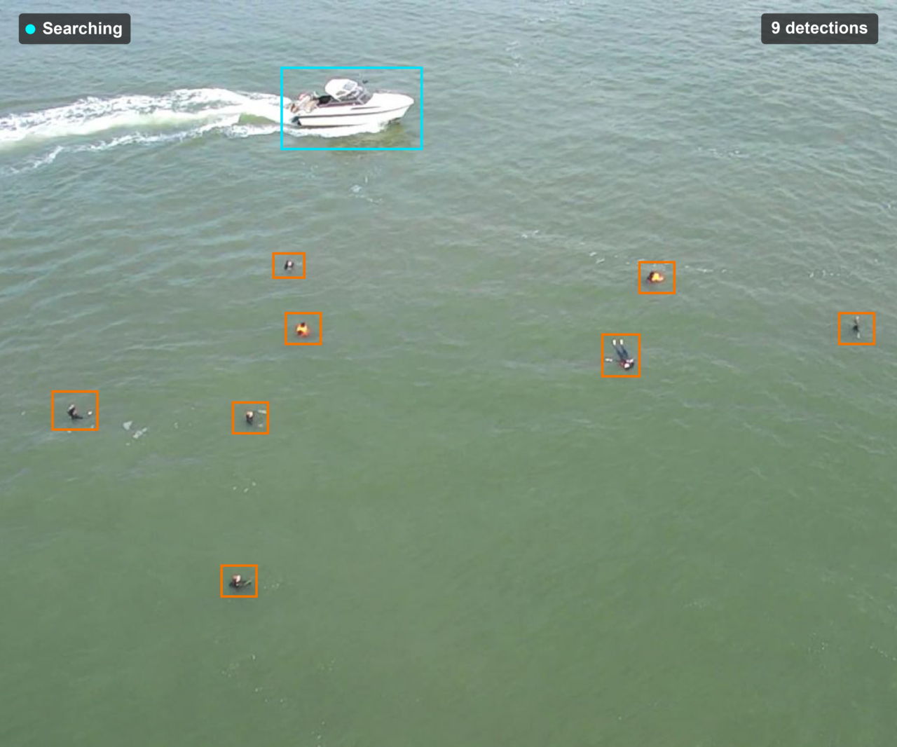 ALFRED operator view: aerial frame with a boat and swimmers, each outlined by the detection model